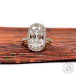 Front view of elongated cushion moissanite halo ring with pavé band