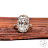 Front view of elongated cushion moissanite halo ring with pavé band