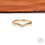 Front view of starburst curved stacking wedding band with delicate round accents.