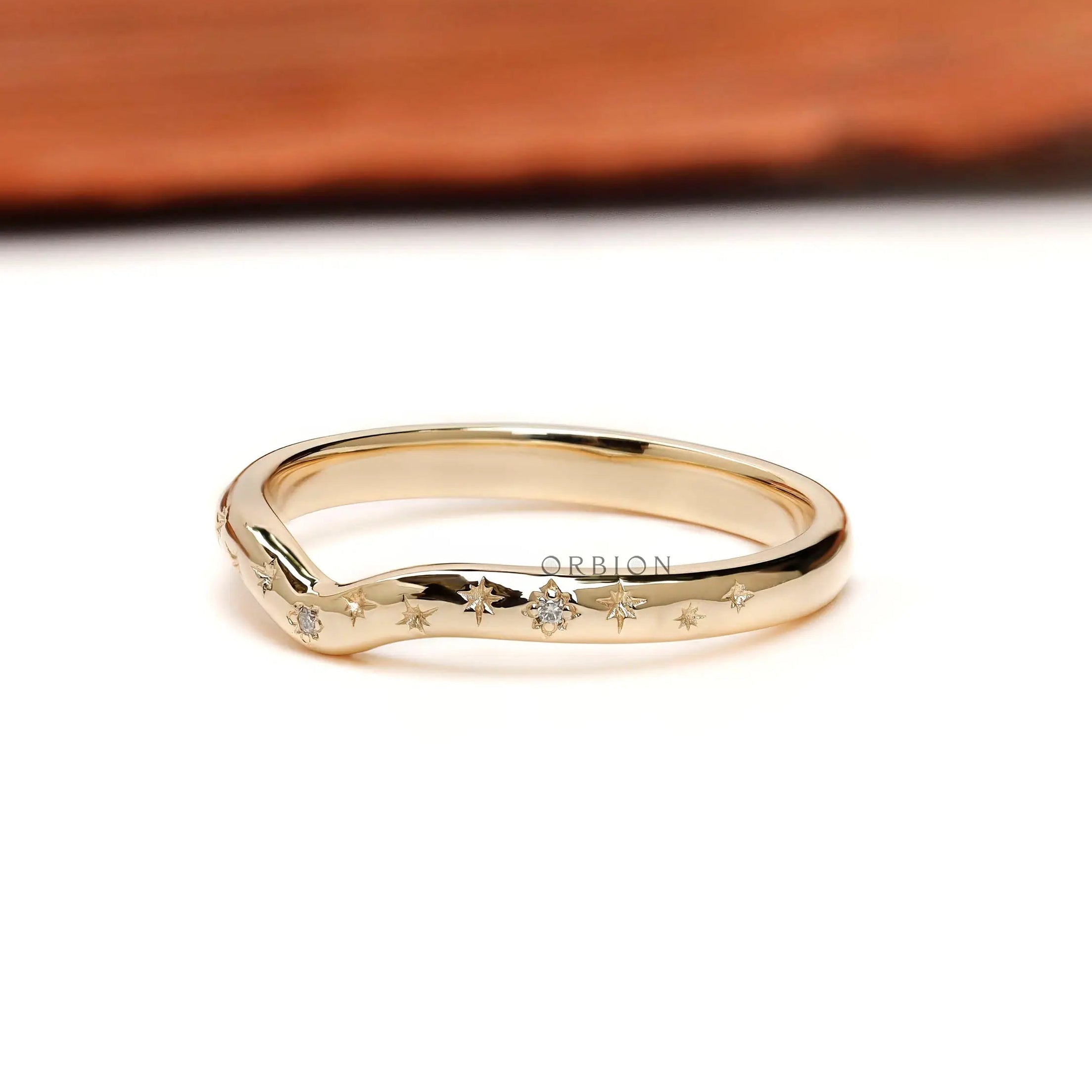 Angled view of curved nesting band featuring starburst details.
