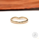 Back view of curved nesting wedding band with starburst details on both shoulders.