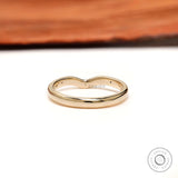 Back view of curved nesting wedding band with starburst details on both shoulders.