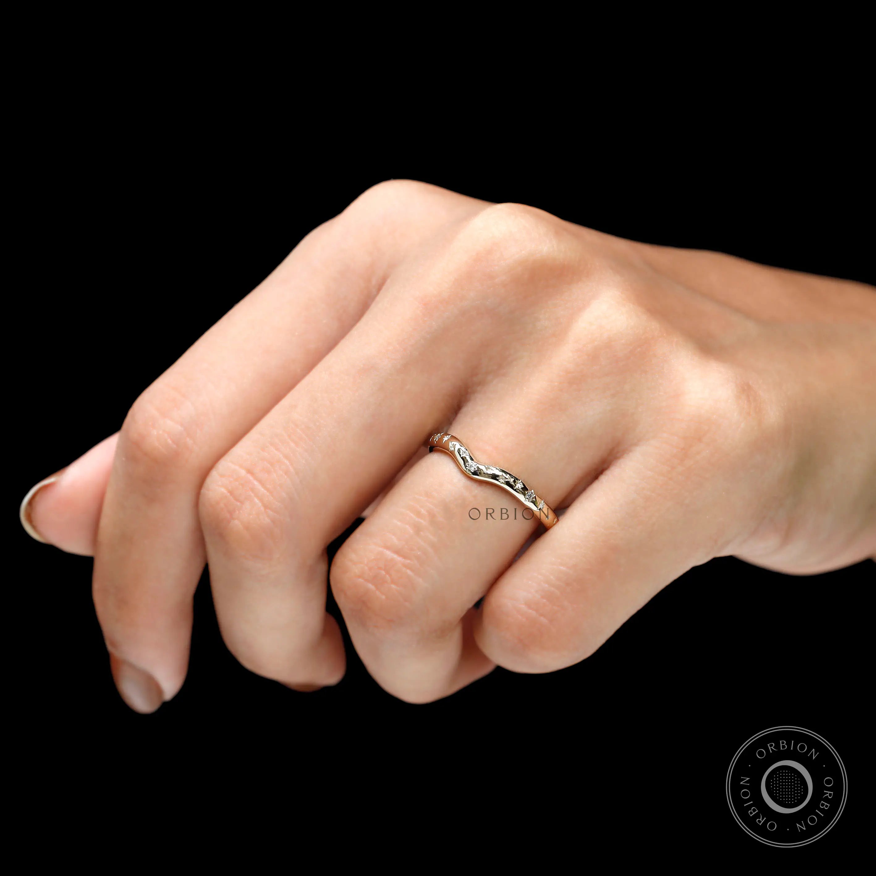 Angled close-up of starburst-inspired curved chevron stacking band.
