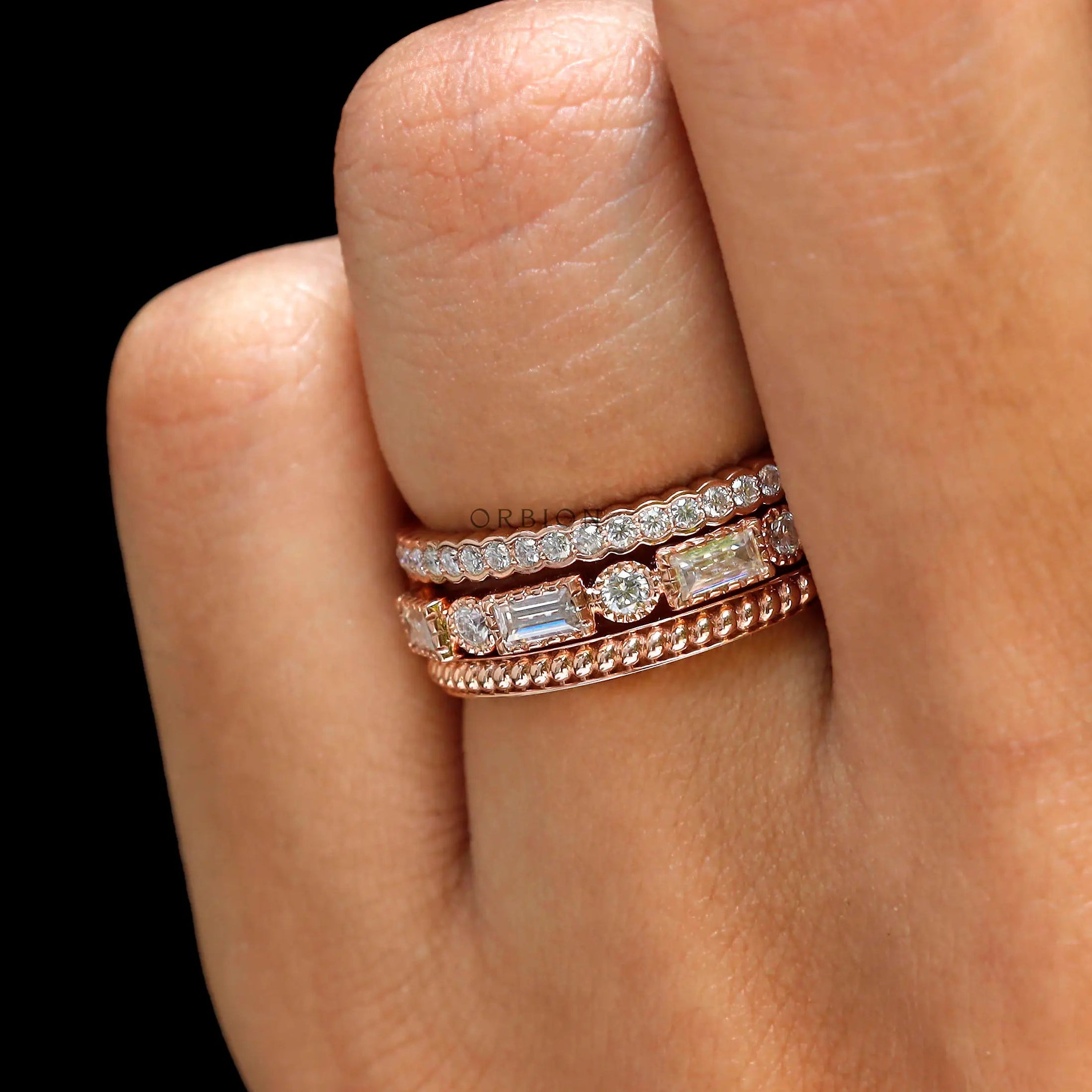 On-hand close-up of trio wedding set stack