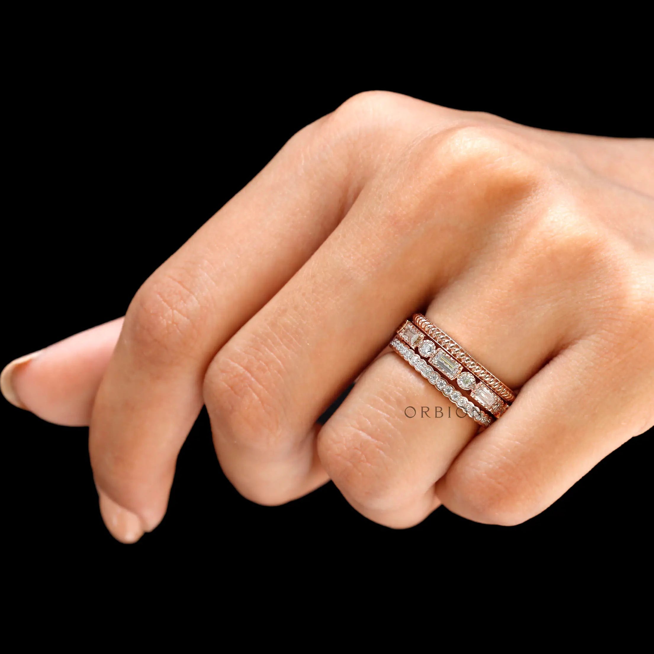 Lifestyle hand shot highlighting trio ring set sparkle