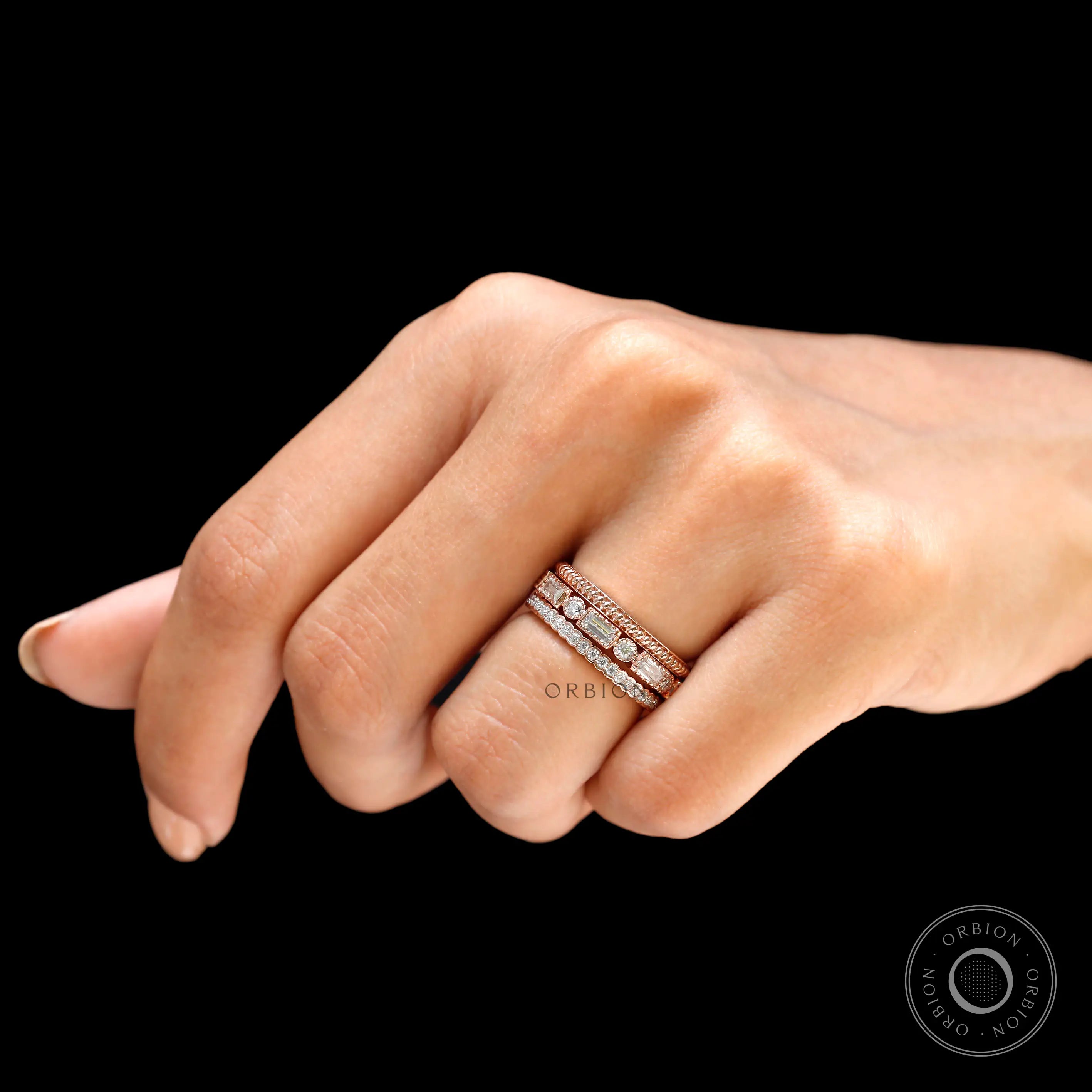 Lifestyle hand shot highlighting trio ring set sparkle