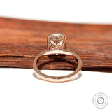 High polish rose gold band with radiant bezel setting