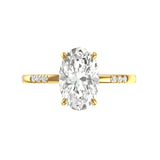 Top view oval moissanite engagement ring in yellow gold on white background