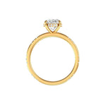 Side profile oval ring with hidden halo in yellow gold on white background