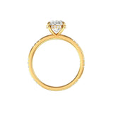 Side profile oval ring with hidden halo in yellow gold on white background