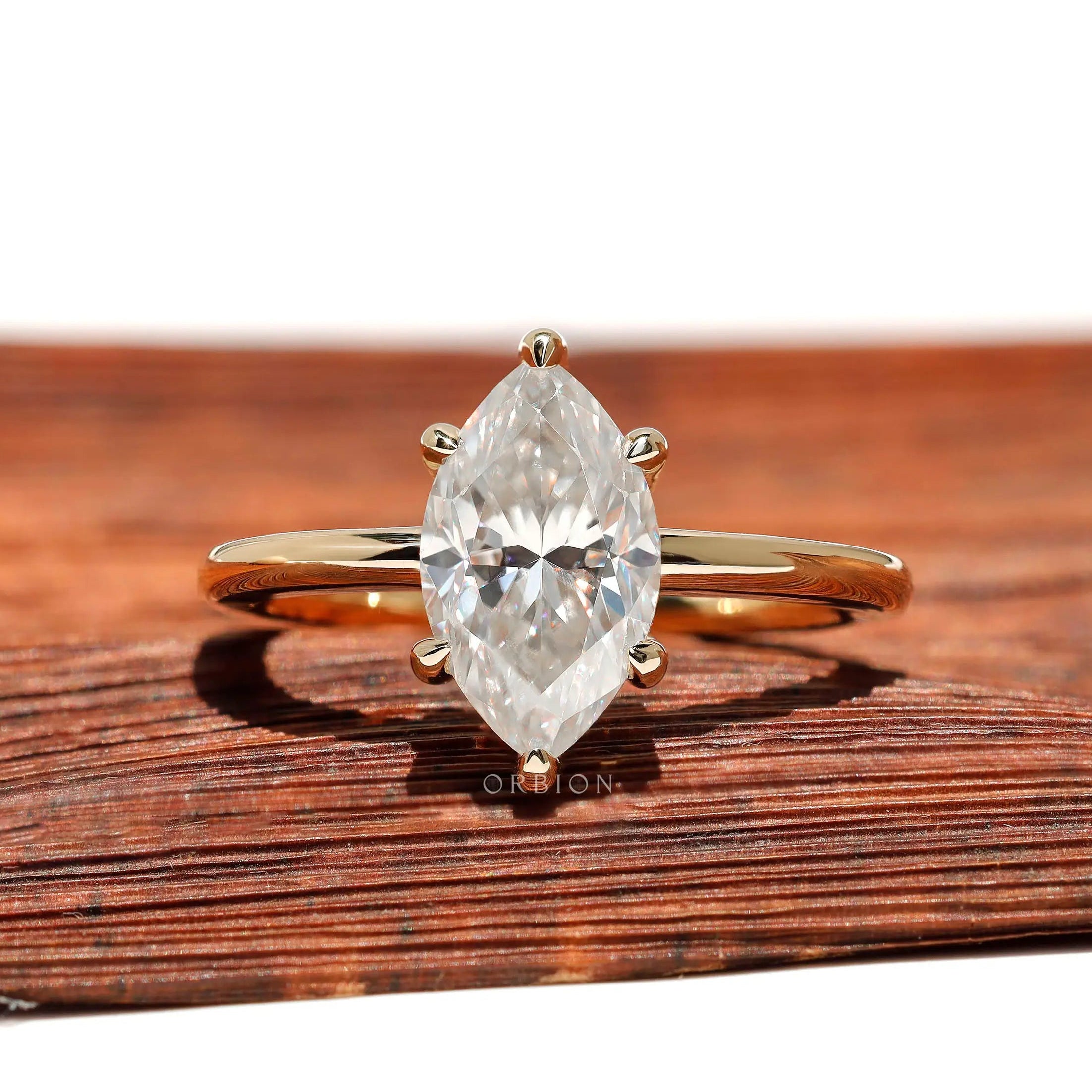 Front view marquise moissanite 6-prong solitaire ring in yellow gold.