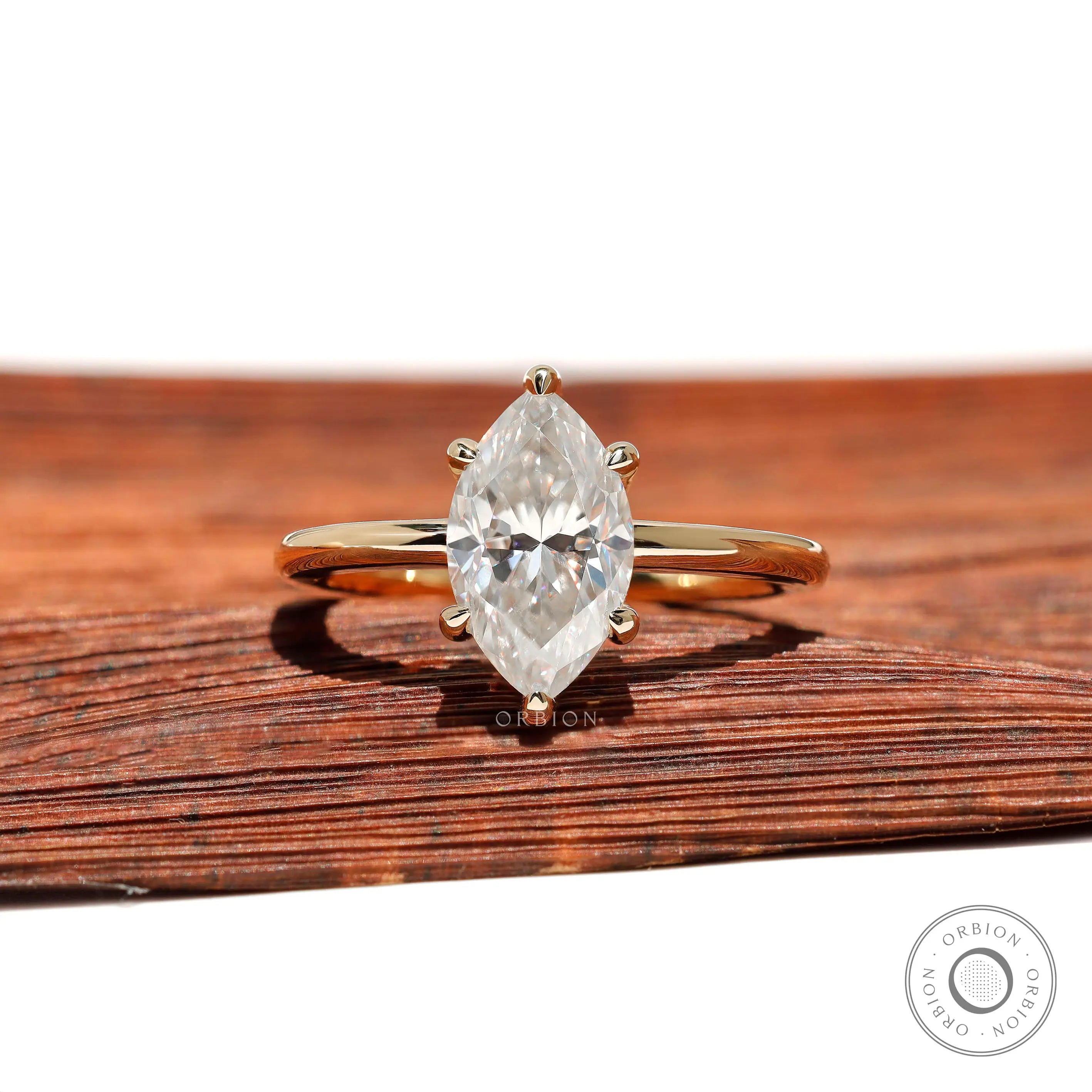 Front view marquise moissanite 6-prong solitaire ring in yellow gold.