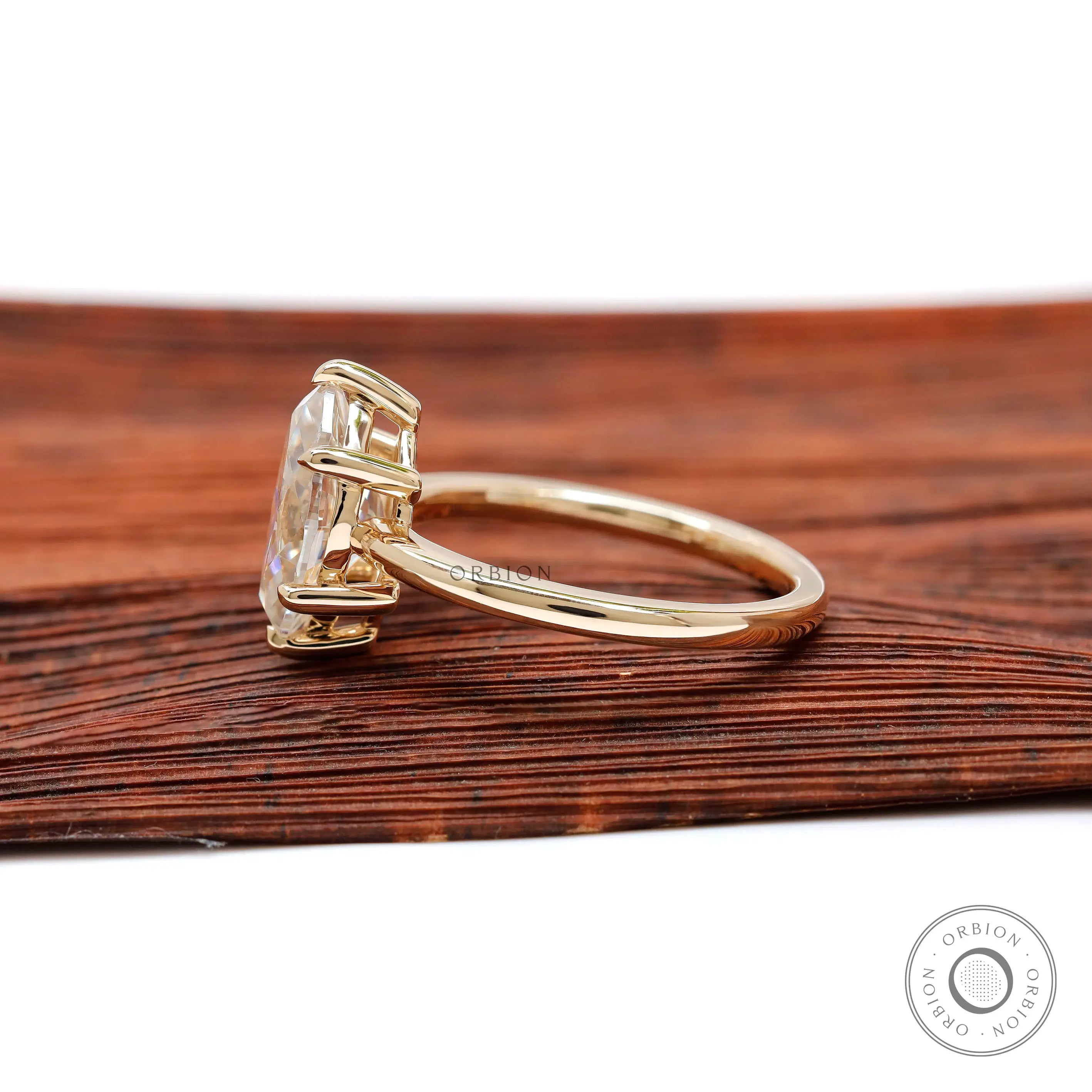 Side profile view highlighting six-prong basket setting and polished band.