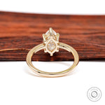 Back view showing open gallery detail beneath marquise moissanite setting.