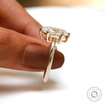 Handheld side view of marquise solitaire showing prong height and basket.