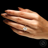 Lifestyle hand pose showing marquise solitaire ring sparkle in yellow gold.