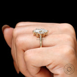 On-finger side profile showing basket setting and smooth yellow gold shank.
