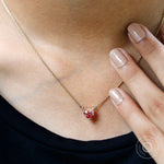 Lifestyle neck view of dainty pink heart diamond pendant necklace worn
