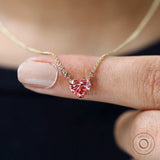 Close-up worn view of pink heart diamond pendant centered on chain