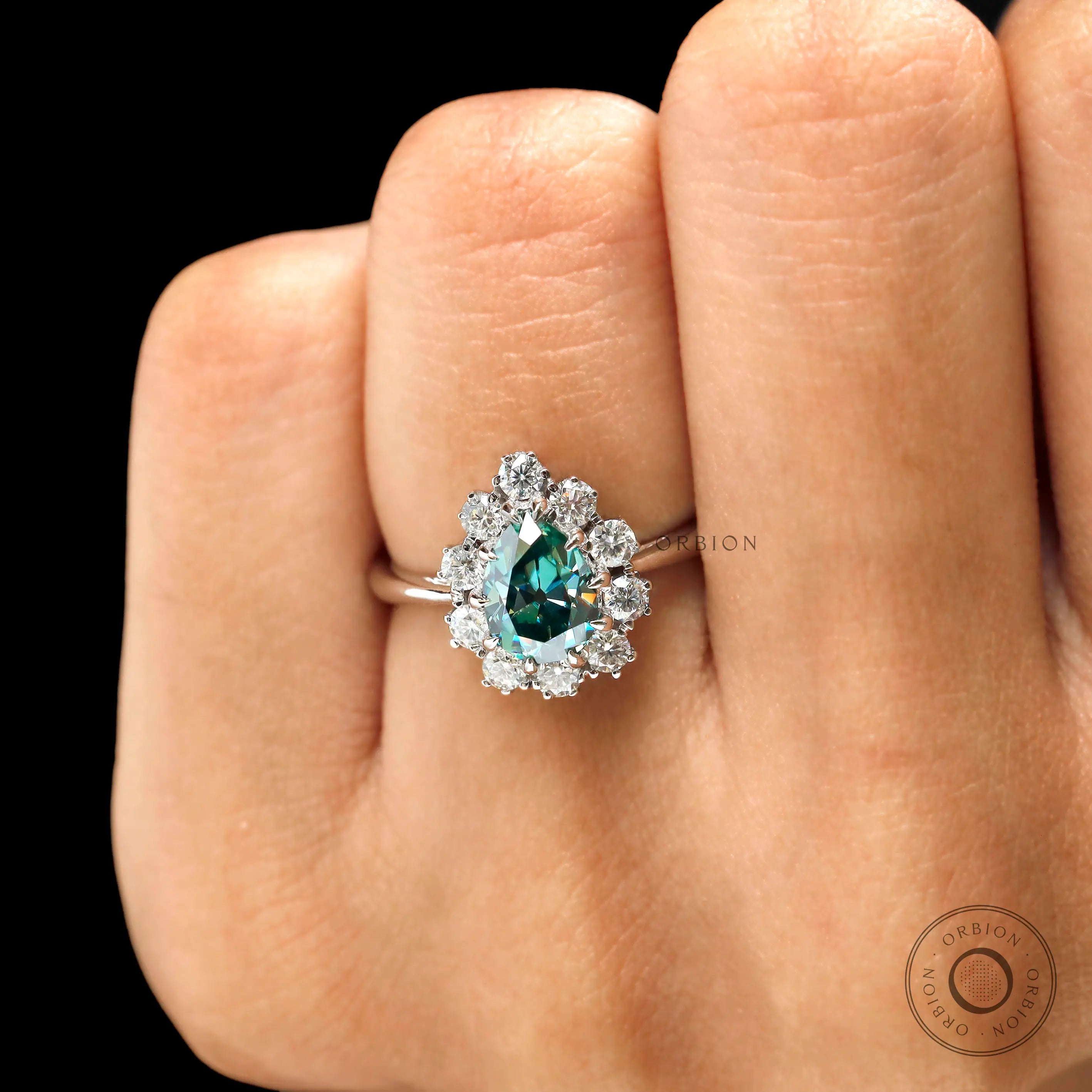 Color stone halo engagement ring on fingure close up