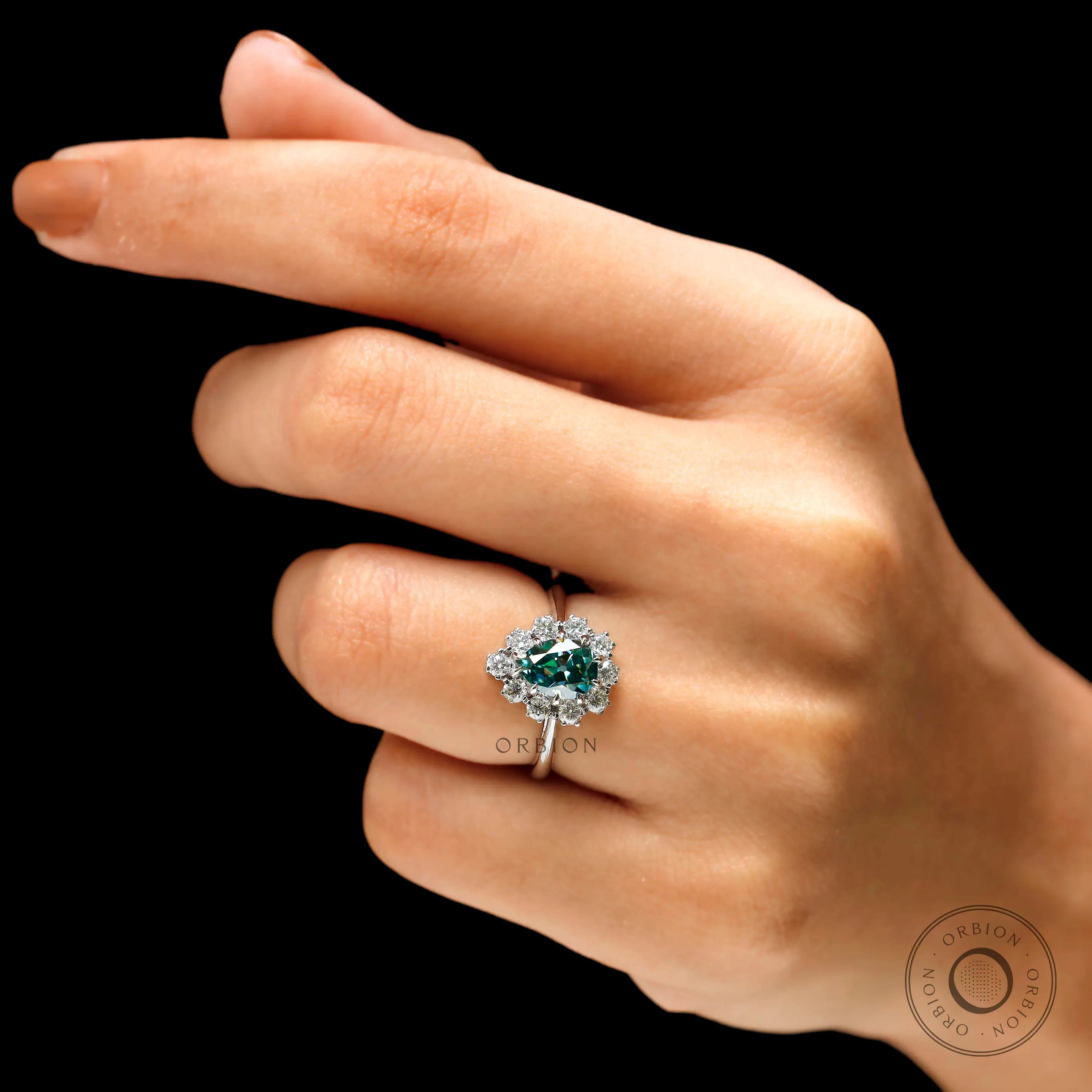 Pear halo blue green moissanite engagement ring on fingure