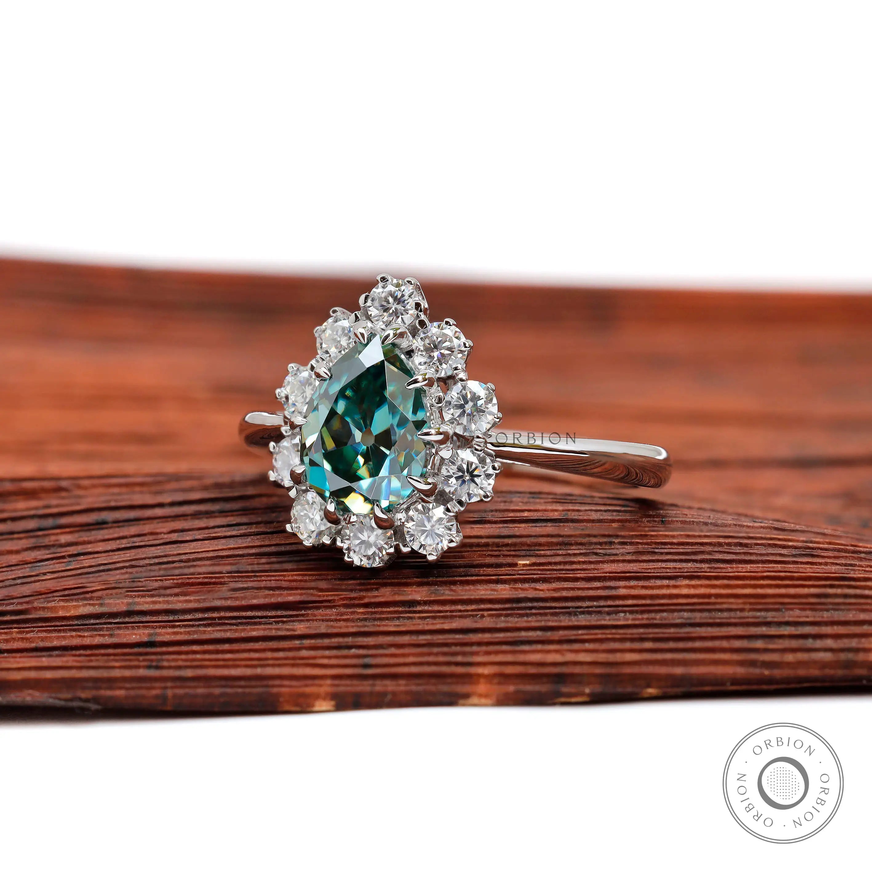 Side profile of pear teal moissanite halo ring