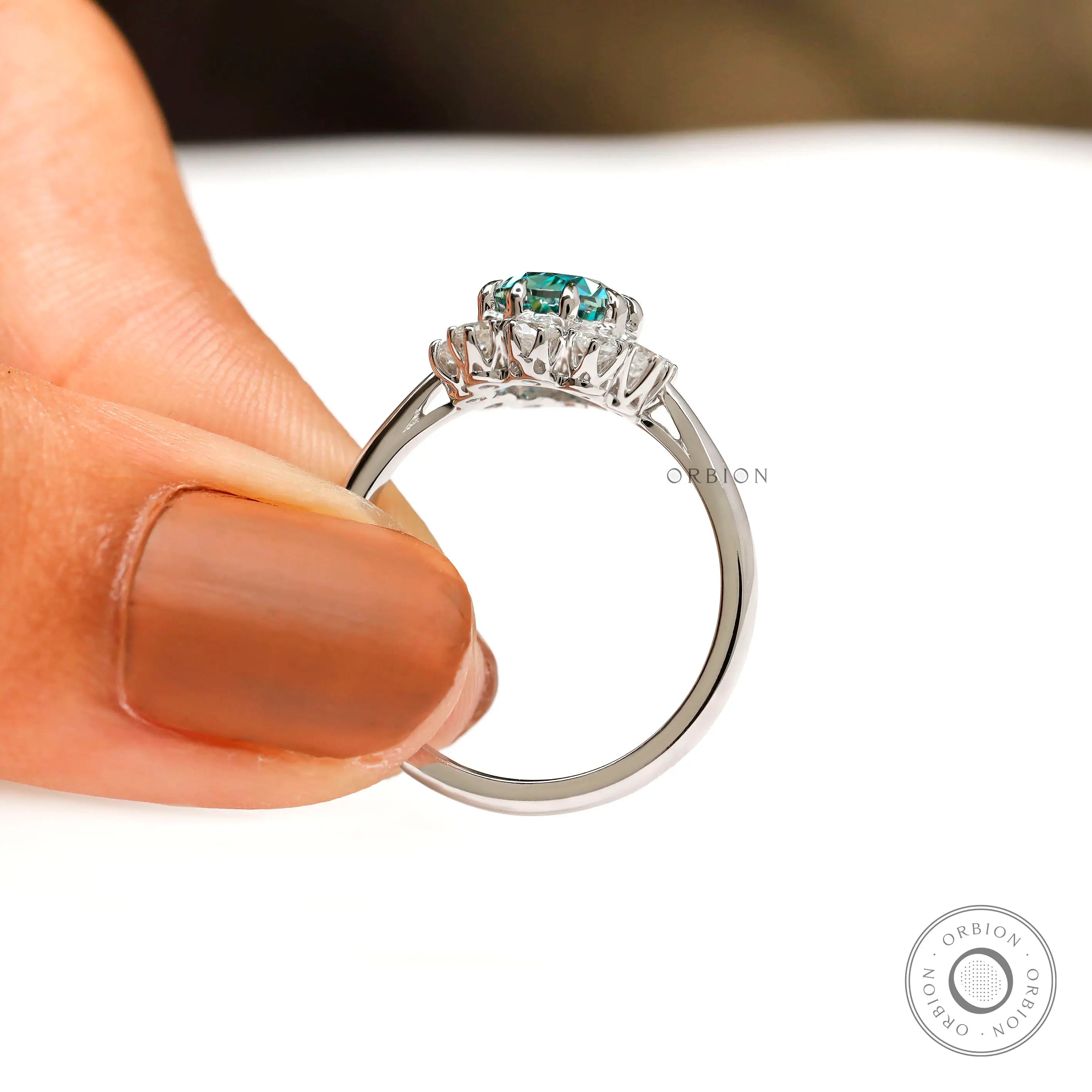 Pear halo moissanite engagement ring side view