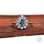 Pear blue green moissanite halo engagement ring front view