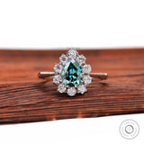 Pear blue green moissanite halo engagement ring front view
