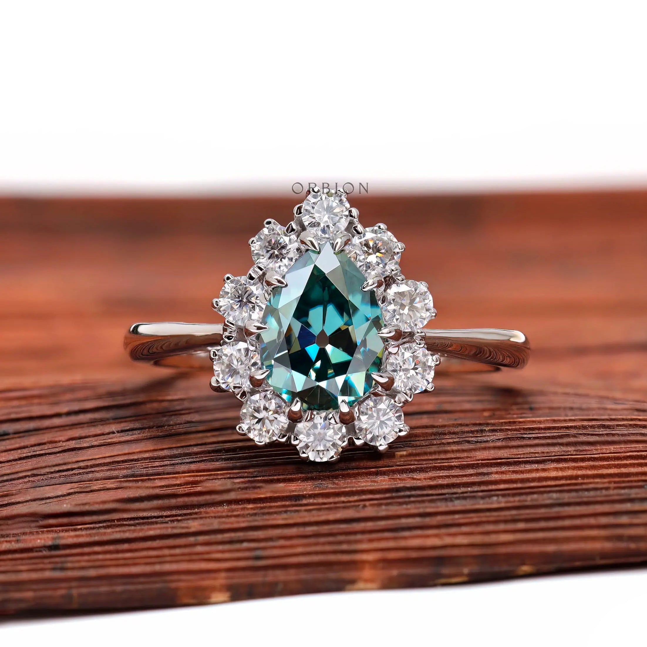 Pear blue green moissanite halo engagement ring front view