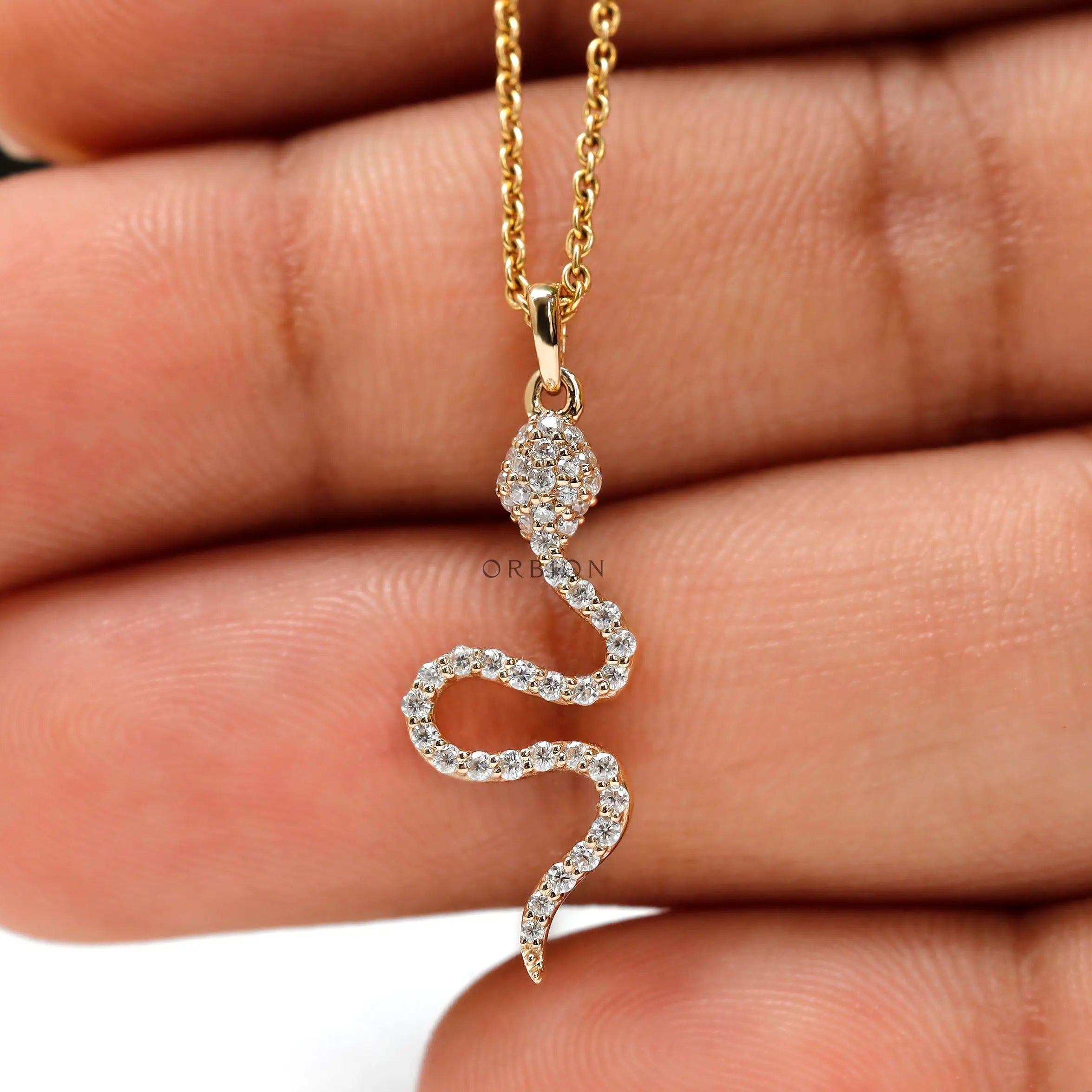 Pave snake pendant in yellow gold