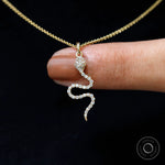 Diamond snake charm pendant in 18k yellow gold, close up sparkle detail