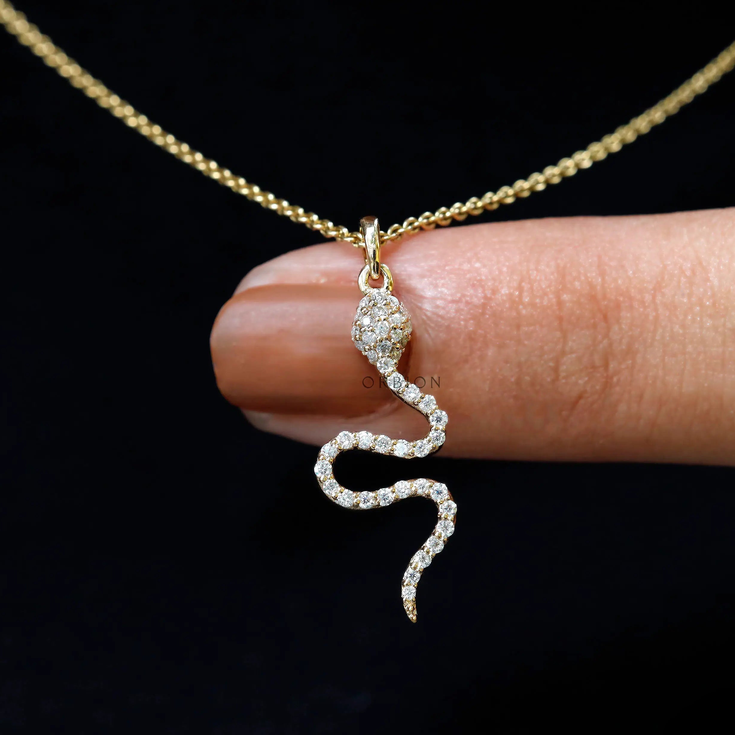 Diamond snake charm pendant in 18k yellow gold, close up sparkle detail