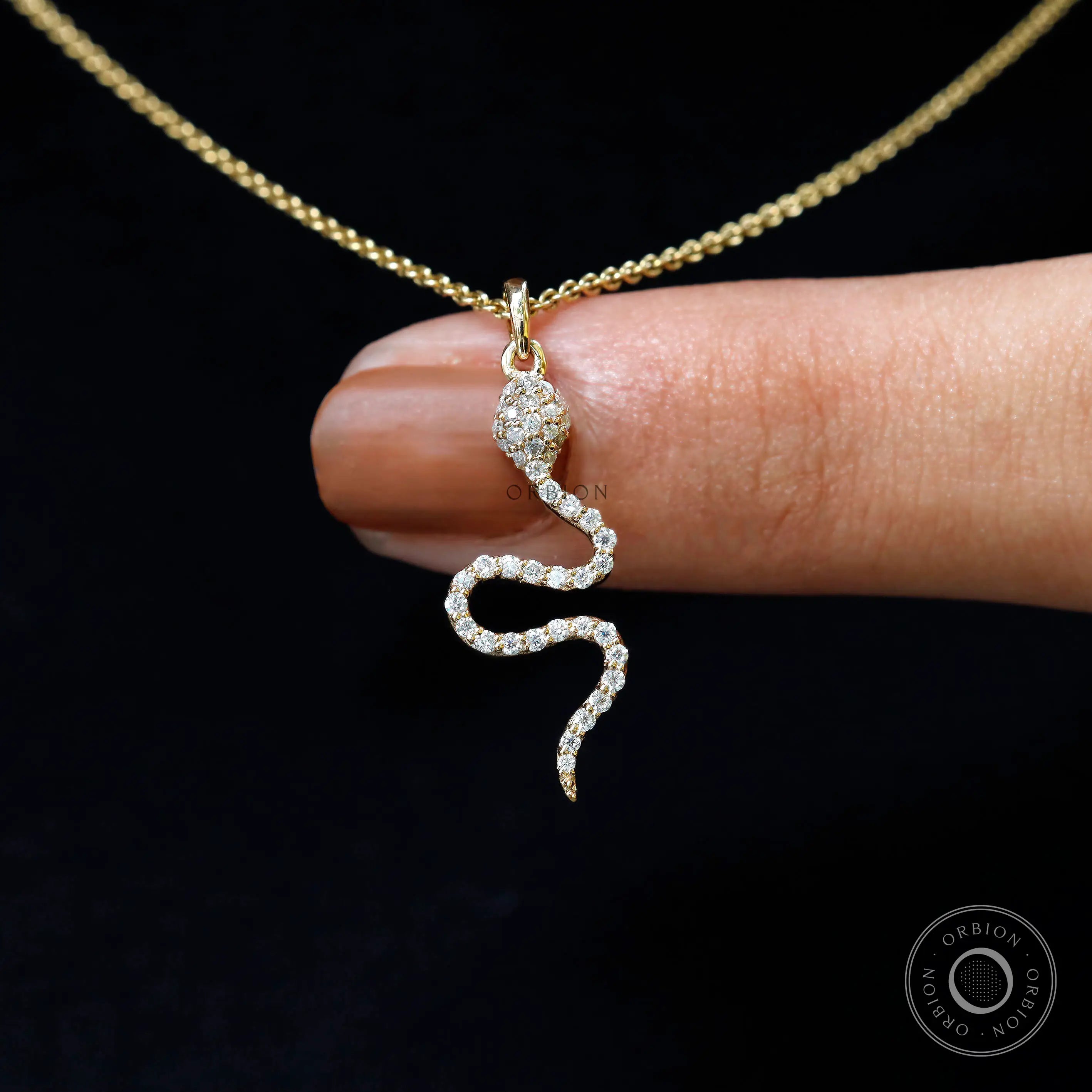 Diamond snake charm pendant in 18k yellow gold, close up sparkle detail