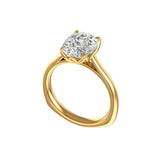 Three-quarter view of elongated cushion moissanite with euro shank in yellow gold.