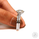 Side profile of the elongated cushion Moissanite engagement ring on a finger, showcasing the brilliant-cut side stones