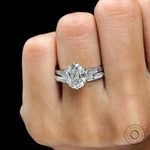 Elongated cushion Moissanite ring, showing off its brilliant-cut side stones and polished white gold band.