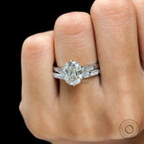 Elongated cushion Moissanite ring, showing off its brilliant-cut side stones and polished white gold band.