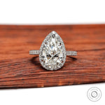 Pear cut lab grown diamond halo engagement ring in white gold front view
