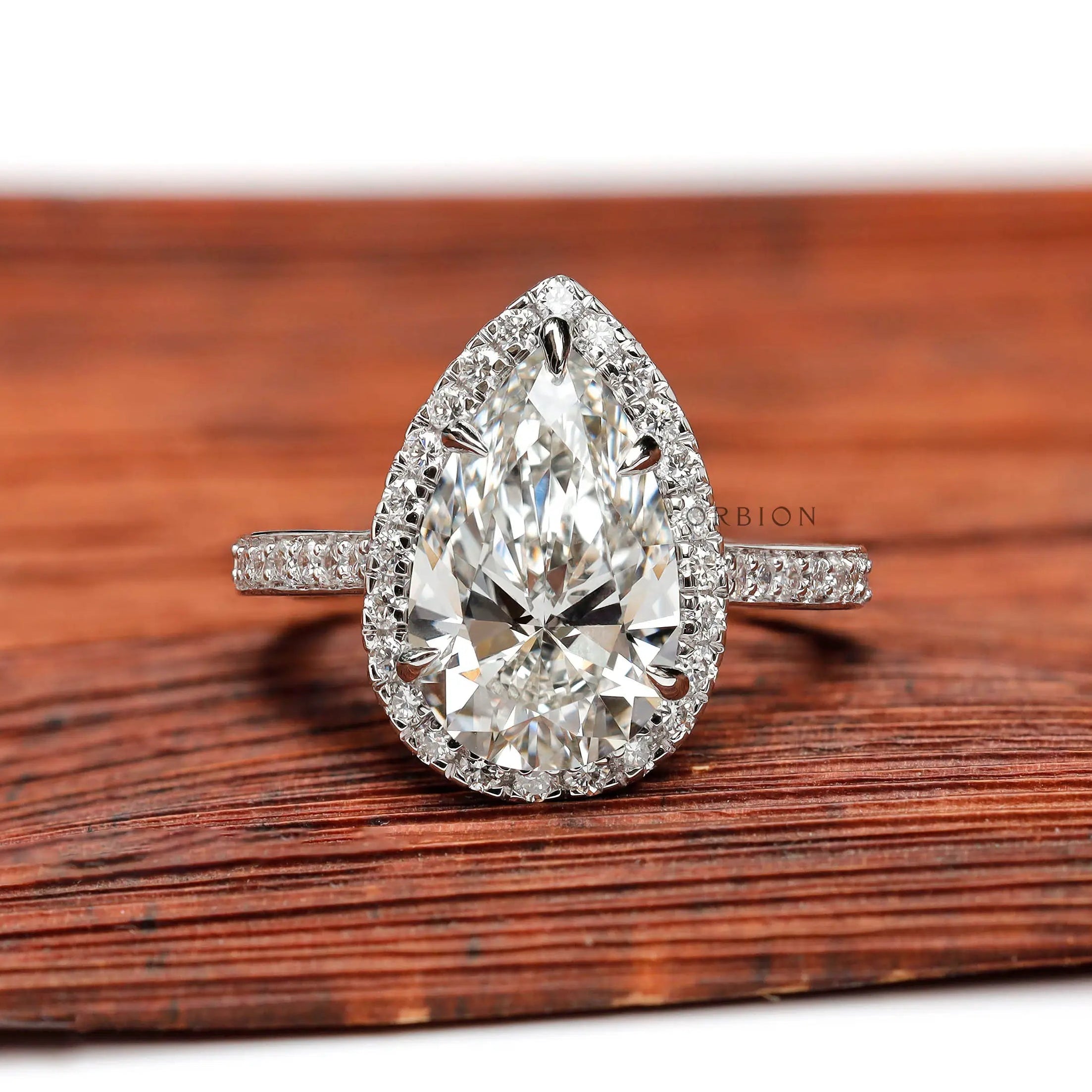 Pear cut lab grown diamond halo engagement ring in white gold front view