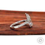Side profile of pear shaped diamond halo ring with pavé band