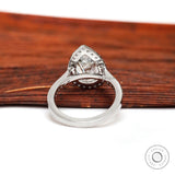 Close up of pear shaped diamond halo with pavé white gold band