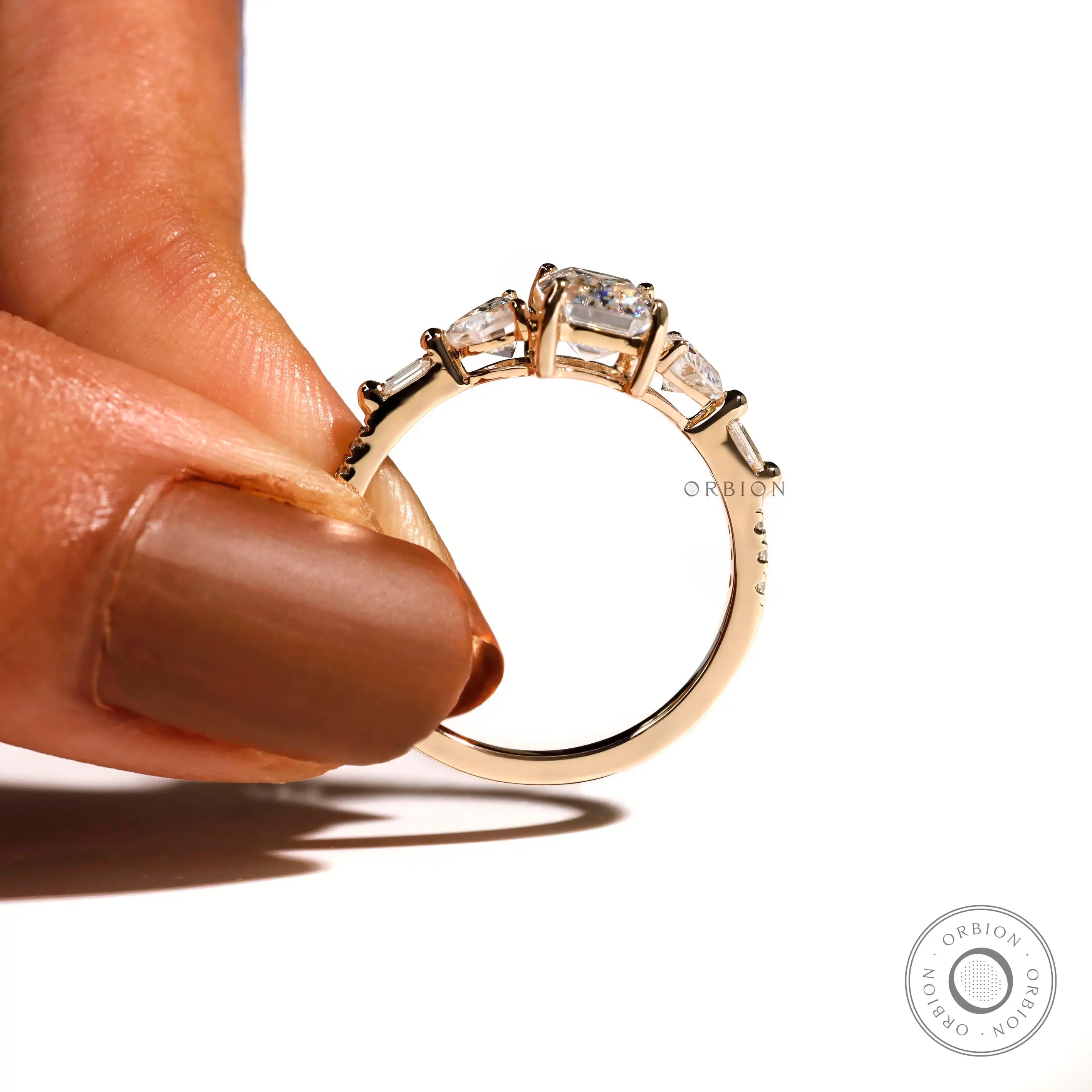 Modern three stone emerald cut ring side profile