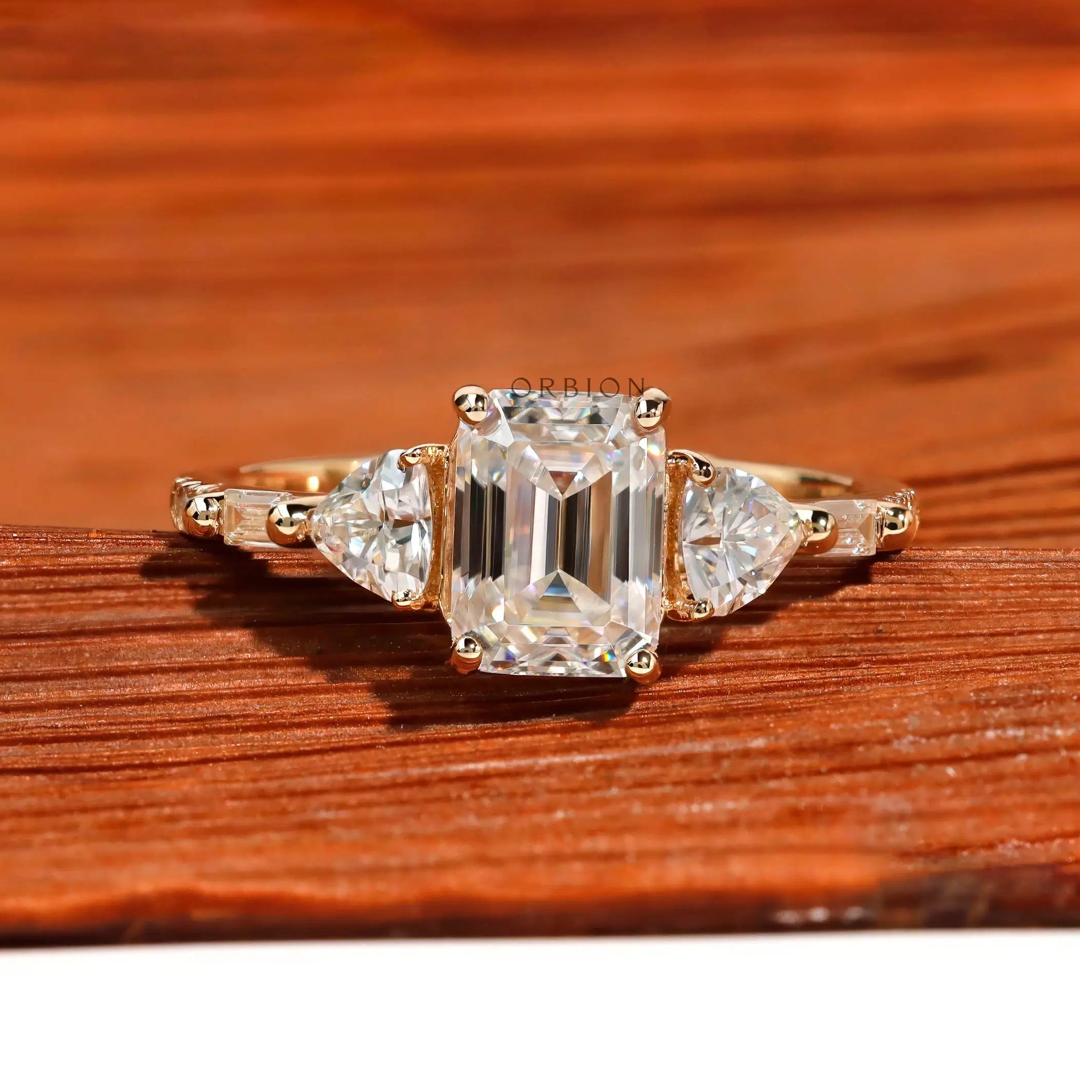 Three stone emerald cut moissanite engagement ring in 14K yellow gold