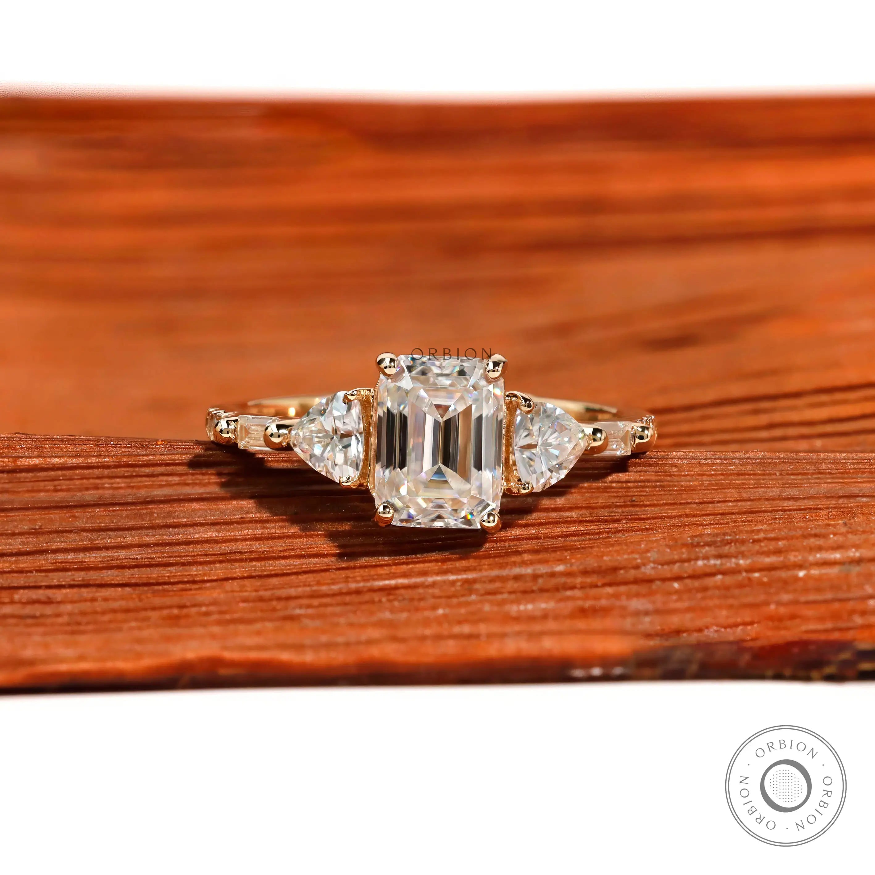 Three stone emerald cut moissanite engagement ring in 14K yellow gold