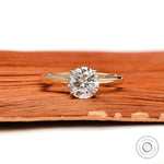 Round moissanite solitaire ring in yellow gold front view