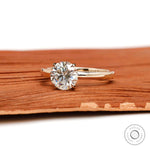 Angled view of round moissanite solitaire ring