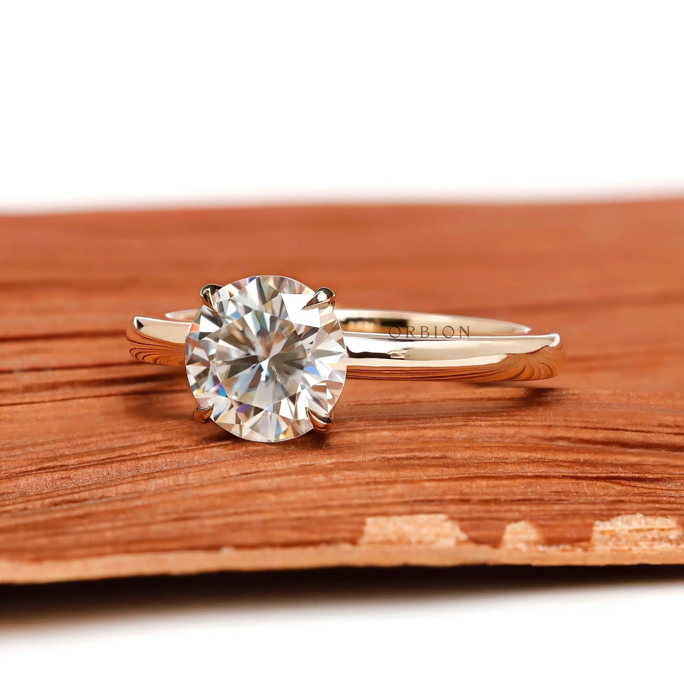Angled view of round moissanite solitaire ring