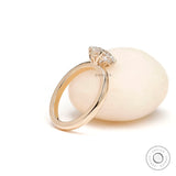 Side view of round moissanite solitaire engagement ring