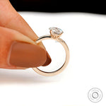 Handheld view of round moissanite solitaire ring